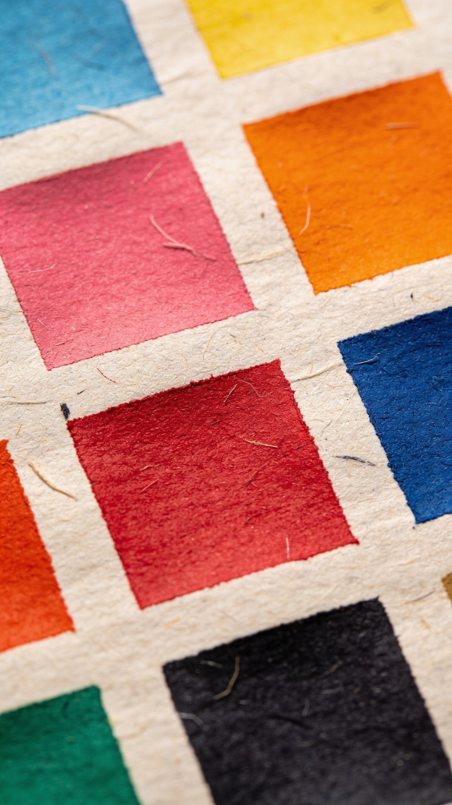 Closeup of a bold color palette swatch on textured paper